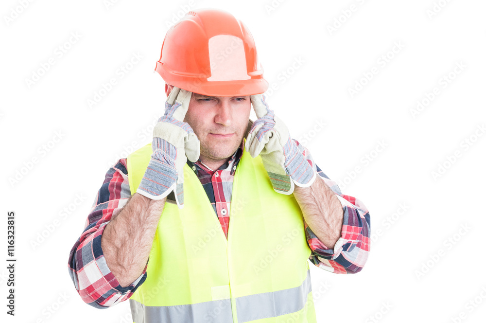 Stressed male builder suffering from headache Stressed male builder suffering from headache