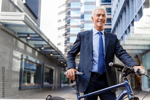 Successful businessman riding bicycle © Sergey Nivens