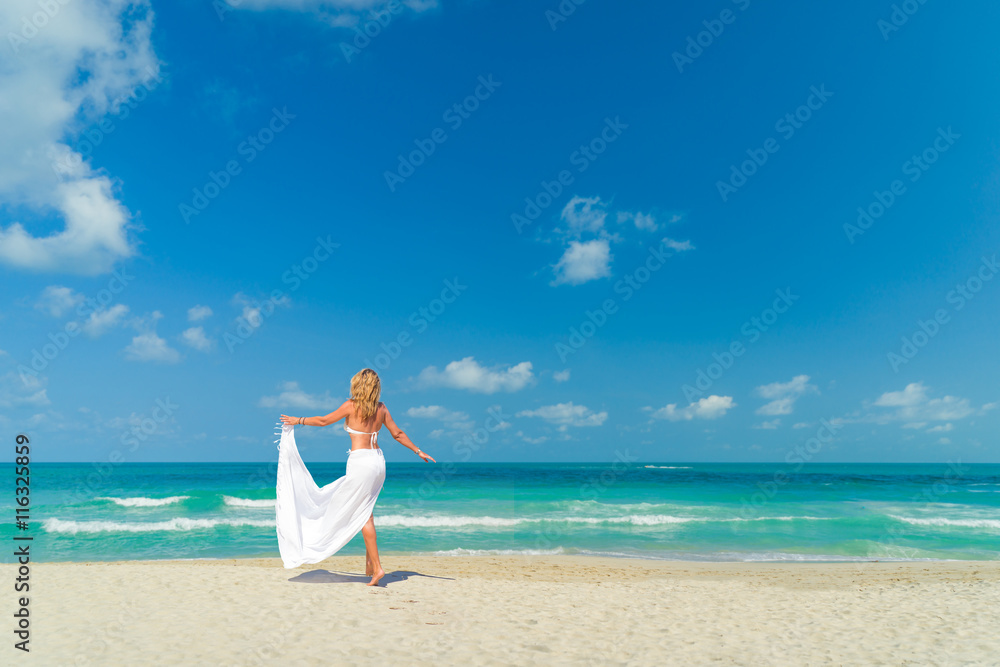 Woman walking on the tropical beach