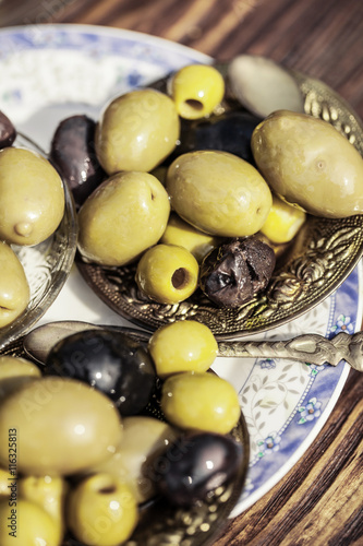 Bowl filled with fresh black olives served as an accompaniment or appetizing snack
