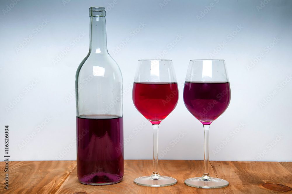 Wine glass and bottle on a wooden table Wine glass and bottle on a wooden table