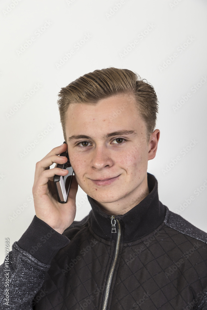 handsome teenage boy in black shirt with mobile handsome teenage boy in black shirt with mobile