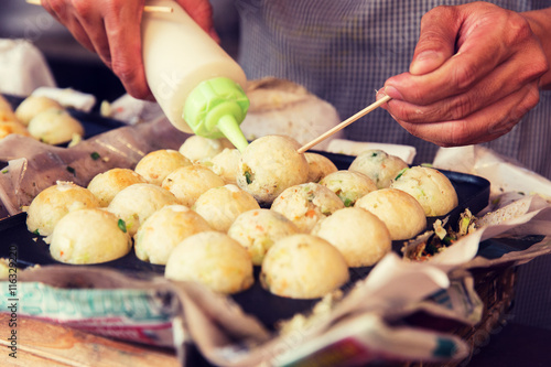 cook stuffing dough or rice balls at street market