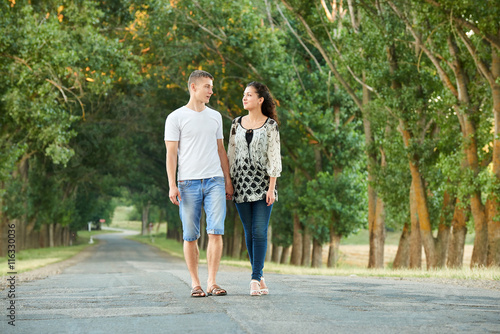 happy young couple walk on country road outdoor, romantic people concept, summer season