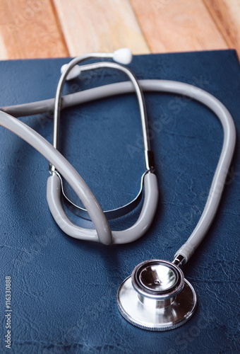 top view of Medicine doctor hand working with modern computer and smart phone on wooden desk as medical concept.