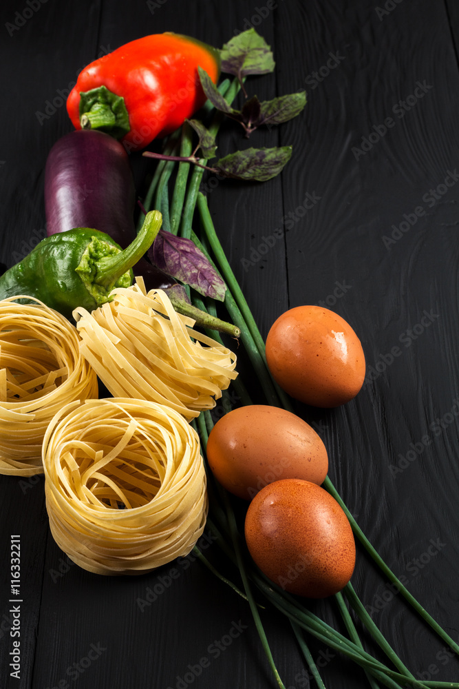 pasta and vegetables on black background pasta and vegetables on black background