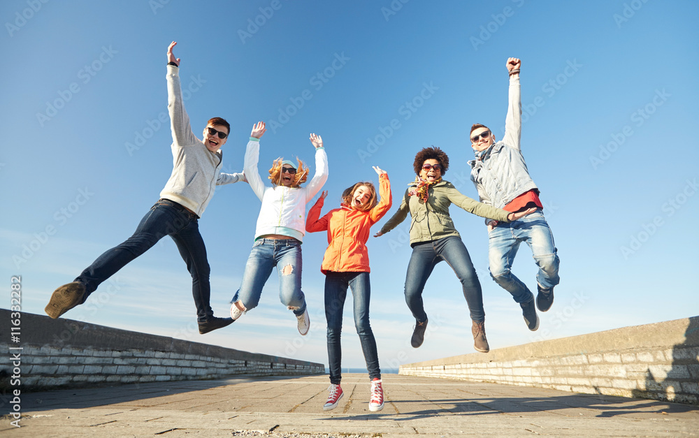 smiling friends in sunglasses laughing on street smiling friends in sunglasses laughing on street