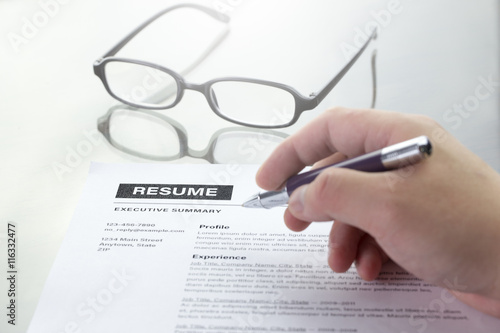 Resume information, pen, pencil and glasses.