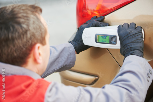 Photography colourist man selecting color of car with paint matching scanner