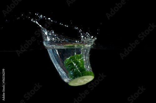 Sliced cucumber splashing water