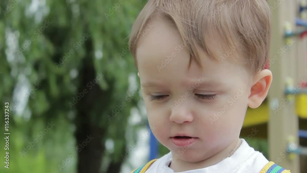 The boy shows emotion on the face smile close up The boy shows emotion on the face smile close up