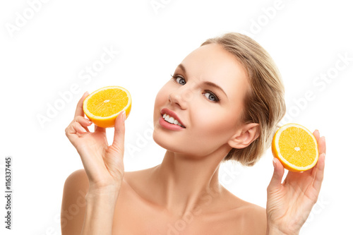 Young woman with orange in her hands