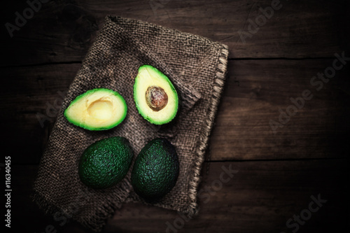 Halved avocado on a rustic table. Top view avocados, image with