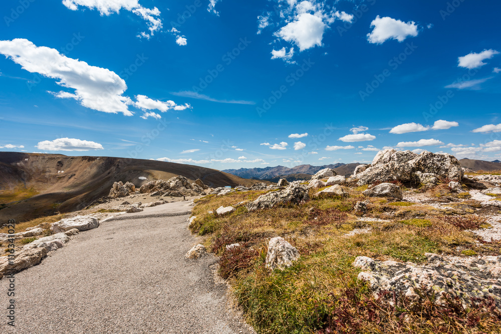 A landscape view of a peak in the Rocky Mountains with trail path in Colorado, USA A landscape view of a peak in the Rocky Mountains with trail path in Colorado, USA