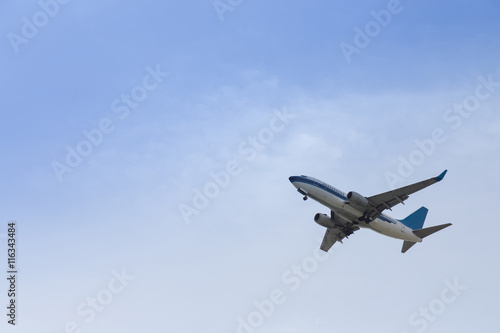 commercial airplane flying in the blue sky