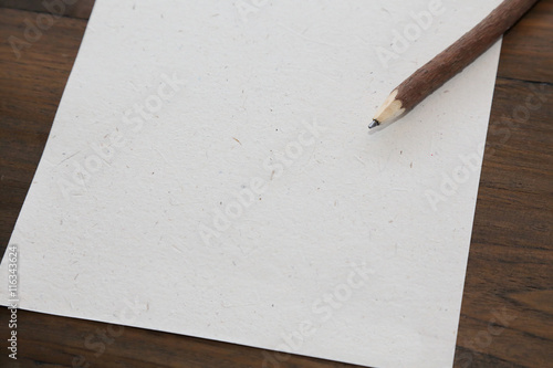 pencil with blank  paper on old wood table