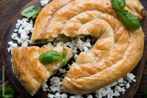 Close-up of baked burek pie with cheese and spinach stuffing
