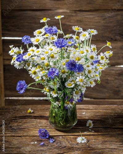 Wallpaper Mural Bouquet of chamomiles and cornflowers in the vase on the wooden Torontodigital.ca