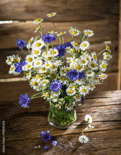 Wallpaper Mural Bouquet of chamomiles and cornflowers in the vase on the wooden Torontodigital.ca
