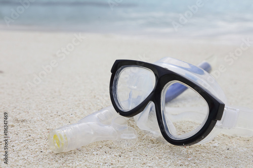 diving mask and a snorkel on the sand