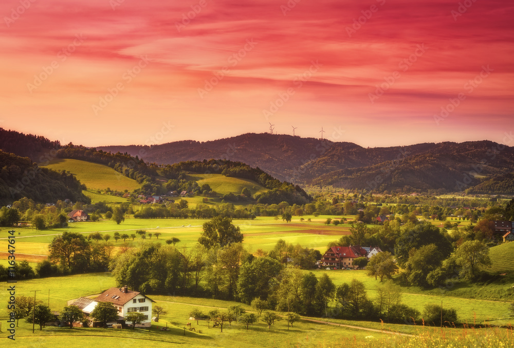 Scenic countryside landscape: summer mountain valley with forests, fields and old houses in Germany, Black Forest