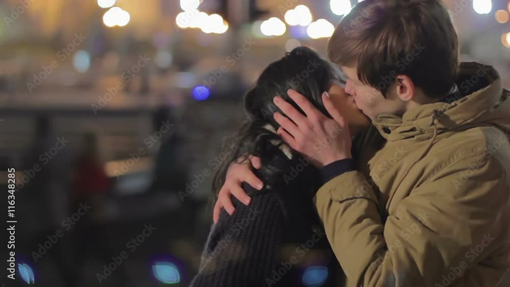 Young couple hugging and kissing on the street, romantic date, first true love Young couple hugging and kissing on the street, romantic date, first true love