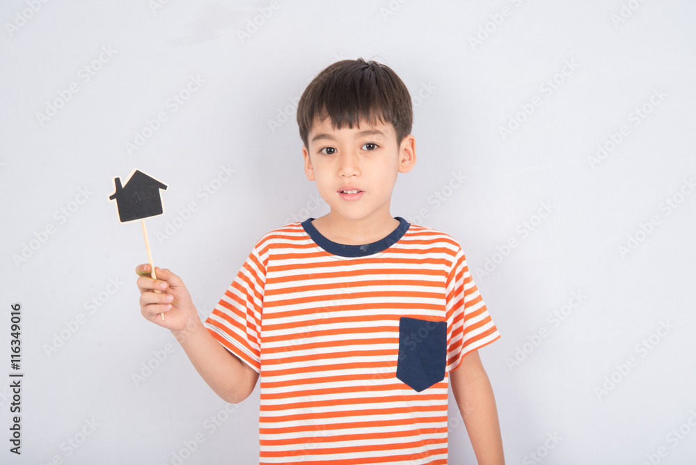 Little boy taking sign board house and heart Little boy taking sign board house and heart