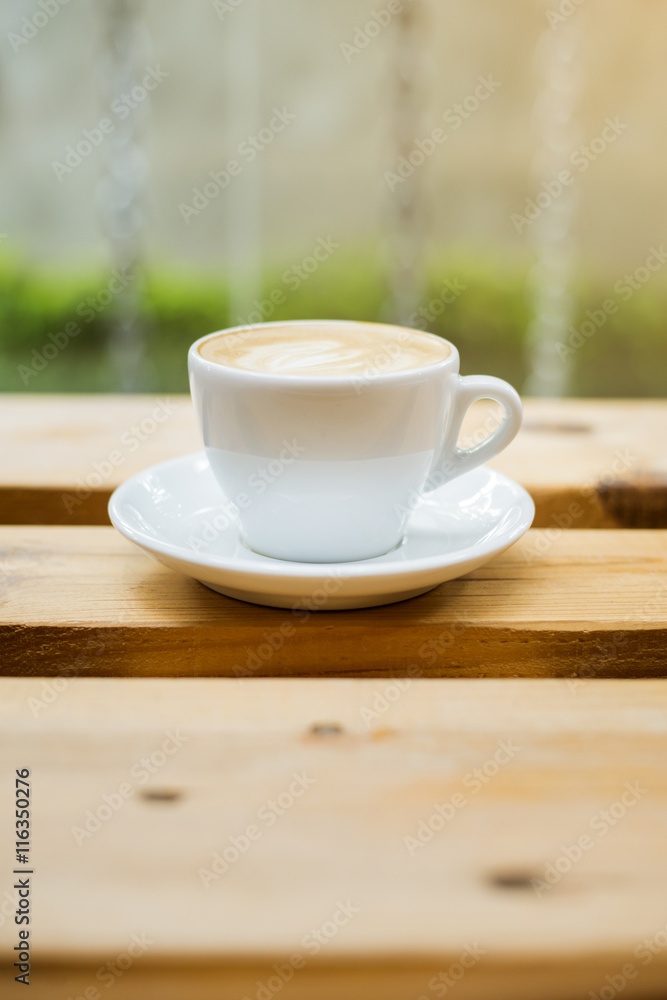 hot latte art on wood table background hot latte art on wood table background