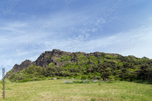 View of Seongsan Ilchulbong ("Sunrise Peak"), archetypal tuff cone, on Jeju Island in South Korea. Copy space.