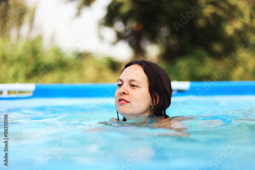 Woman swim in pool. © EduardSV