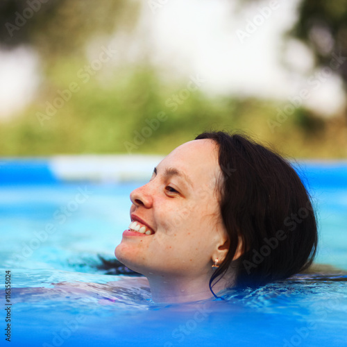 Woman swim in pool.