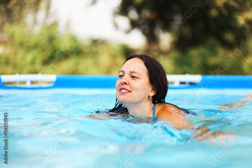 Woman swim in pool.