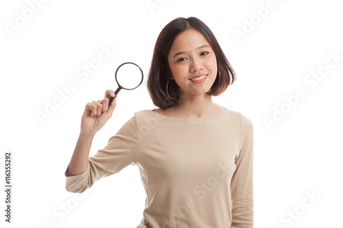 Young Asian business woman with a magnifying glass isolated on white background