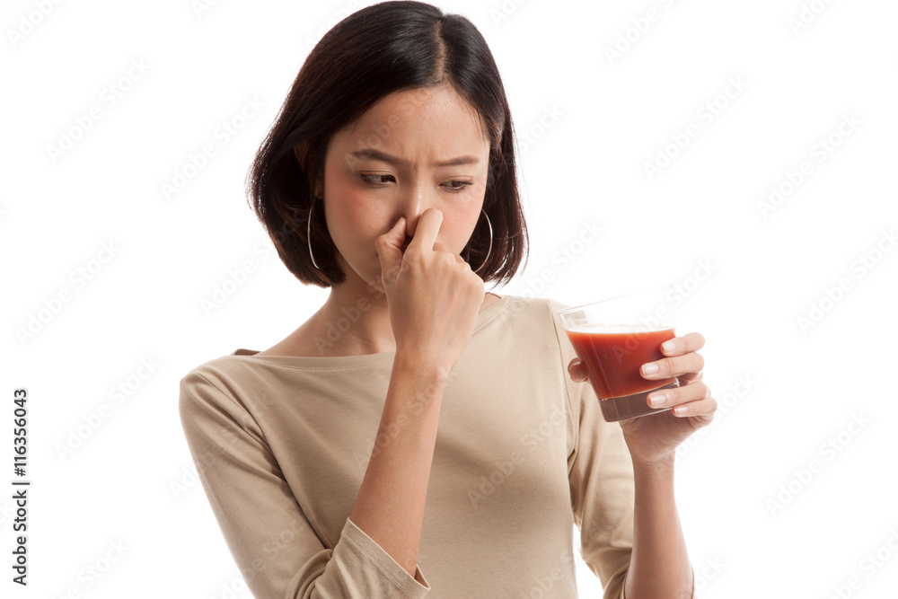 Young Asian business woman hate tomato juice isolated on white background Young Asian business woman hate tomato juice isolated on white background