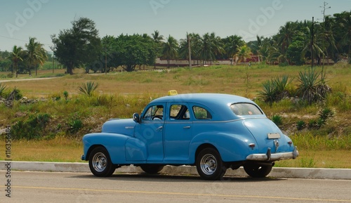 Old American car as a taxi to Havana. © konyt