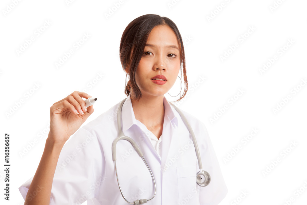Young Asian female doctor with red marker focus at marker isolated on white background Young Asian female doctor with red marker focus at marker isolated on white background