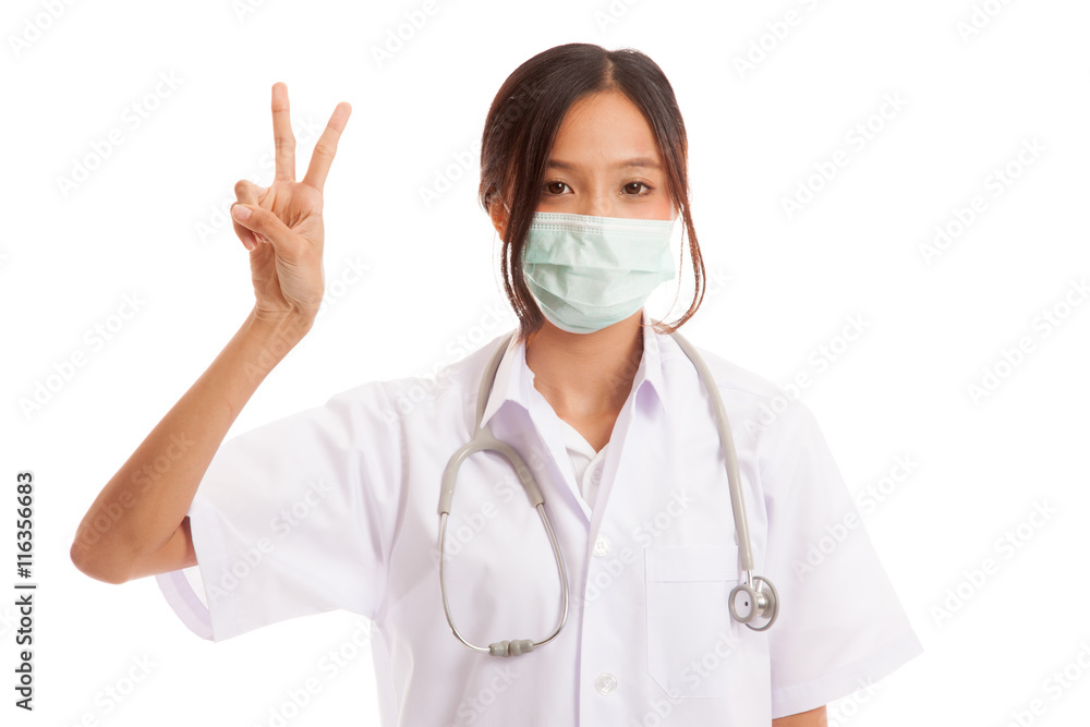 Young Asian female doctor show victory sign isolated on white background Young Asian female doctor show victory sign isolated on white background