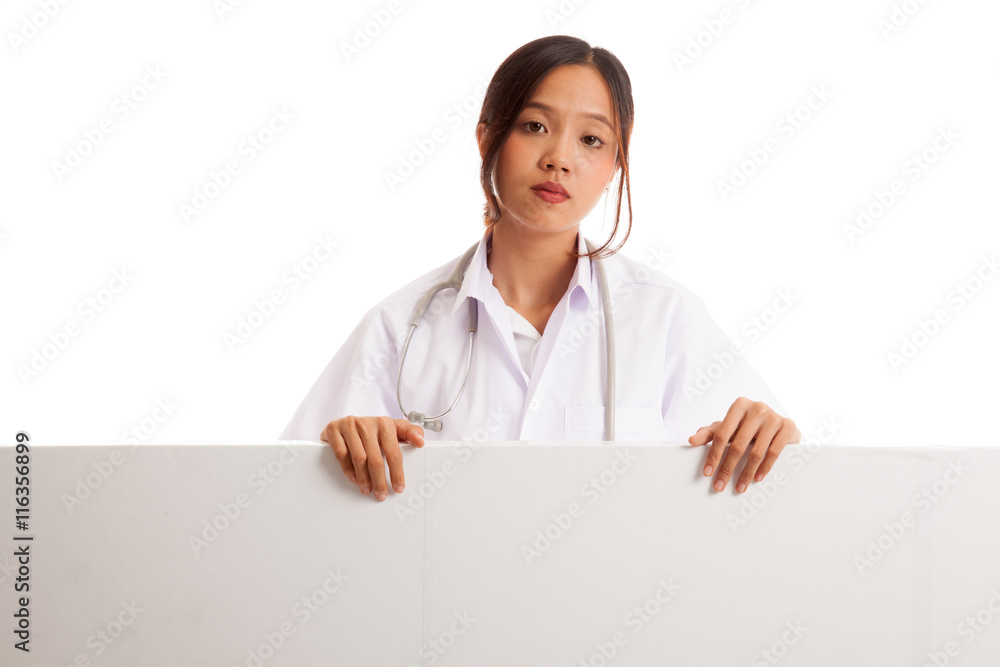 Young Asian female doctor show thumbs up behind blank white billboard isolated on white background Young Asian female doctor show thumbs up behind blank white billboard isolated on white background