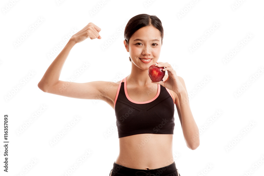 Beautiful Asian healthy girl flexing biceps with red apple isolated on white background Beautiful Asian healthy girl flexing biceps with red apple isolated on white background