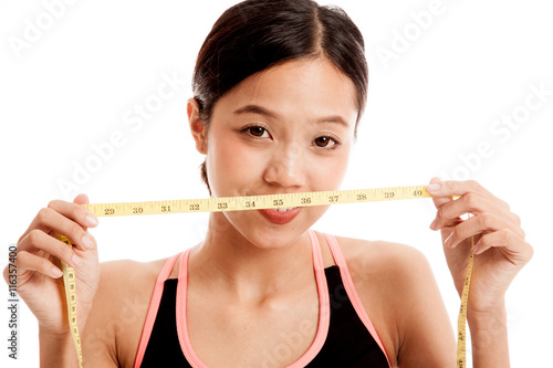 Beautiful Asian healthy girl with measuring tape isolated on white background