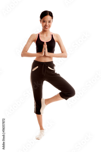 Beautiful Asian healthy girl do yoga pose isolated on white background