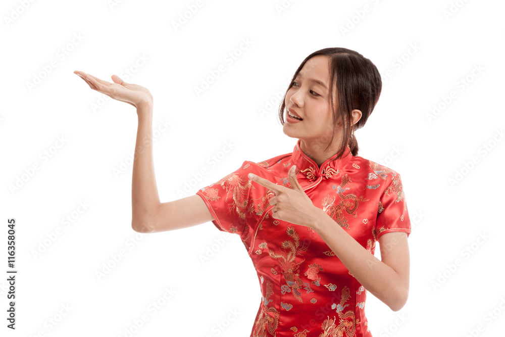 Asian girl in chinese cheongsam dress point to blank space on her hand isolated on white background Asian girl in chinese cheongsam dress point to blank space on her hand isolated on white background