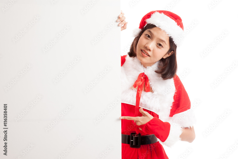 Asian Christmas Santa Claus girl point to blank sign isolated on white background Asian Christmas Santa Claus girl point to blank sign isolated on white background
