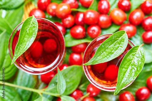 Sweet liqueur made from ripe cornelian cherry and alcohol photo