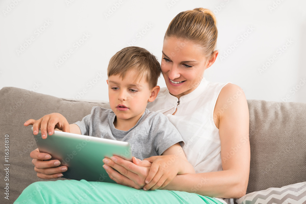 Mother And Son Looking At Digital Tablet Mother And Son Looking At Digital Tablet