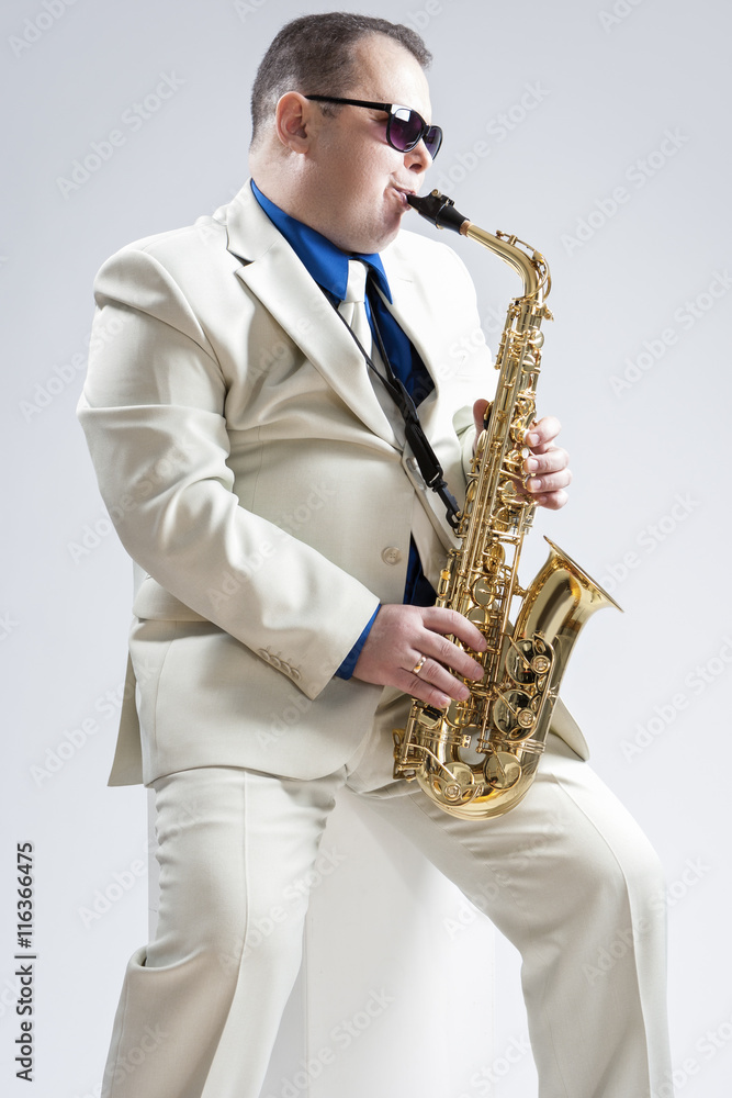 Fototapeta premium Music Concepts. Hadnsome Male Saxophone Player Playing in Studio