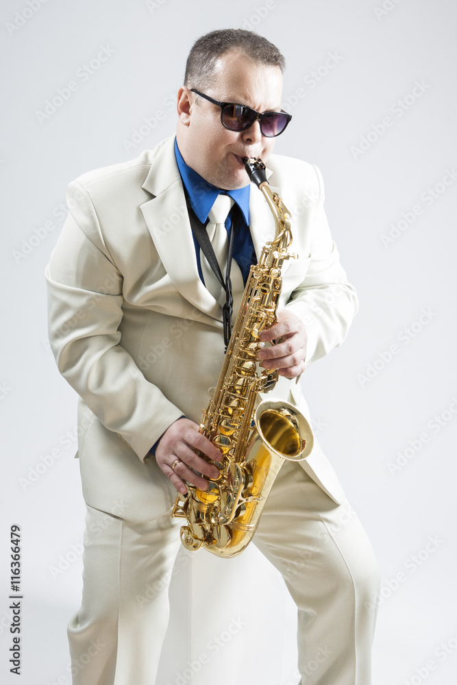 Fototapeta premium Portrait of Expressive Stylish Caucasian Saxophone Player Performing In Studio