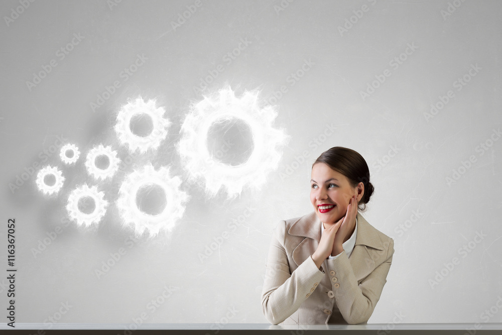 Businesswoman sitting at desk .  Mixed media