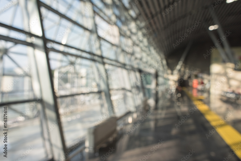 Blurred airport terminal background. Airport or railway hall interior in bokeh. International gate, business trip, arrival or mall. Urban construction.