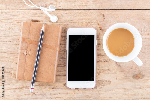 Mobile phone on wood table background, clipping path inside